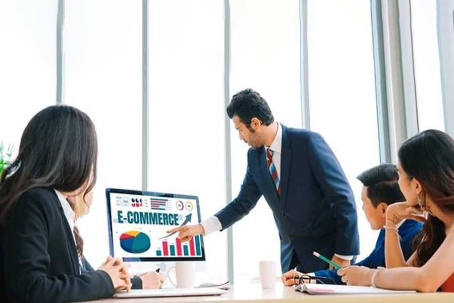 Team discussing ecommerce development strategy with charts and analytics on screen — visual guide for choosing custom ecommerce web development services.